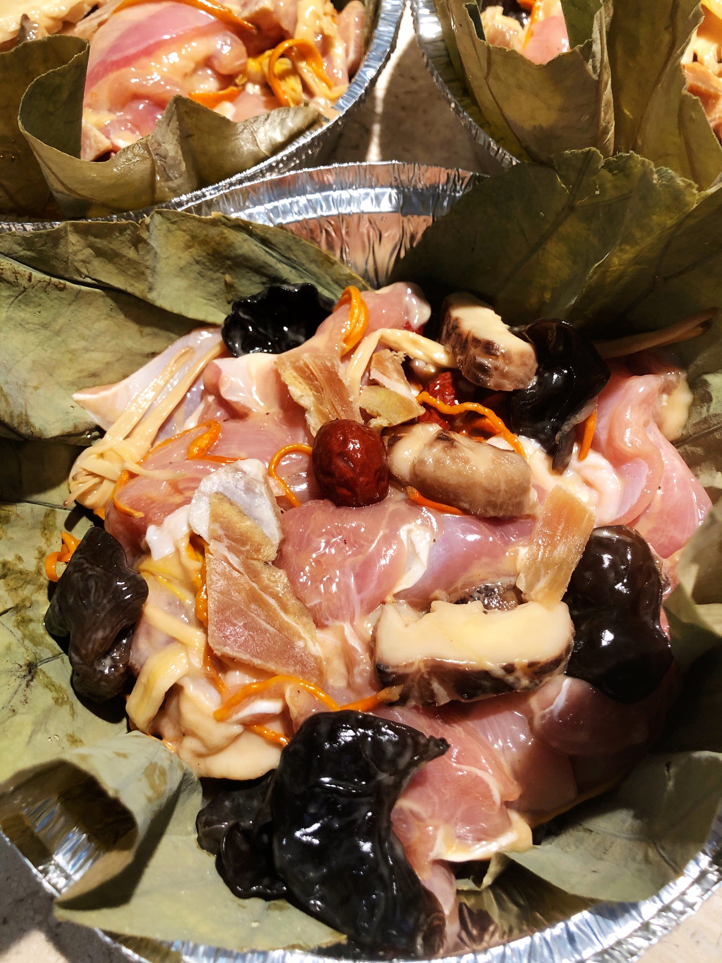 Steamed chicken with mushrooms, lily flowers and fungus in Lotus Leaf 荷葉蟲草花蒸滑雞